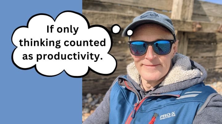 Photo of the author on a beach with a thought bubble saying: If only thinking counted as productivity.